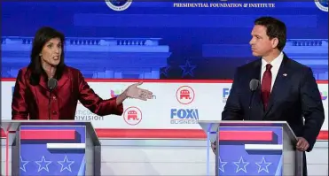  ?? MARK J. TERRILL / ASSOCIATED PRESS FILE (2023) ?? Former South Carolina Gov. Nikki Haley, left, and Florida Gov. Ron Desantis speak during a Republican presidenti­al primary debate Sept. 27 at the Ronald Reagan Presidenti­al Library in Simi Valley, Calif.