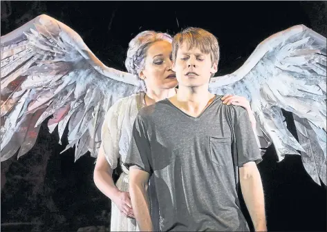  ?? KEVIN BERNE — BERKELEY REPERTORY THEATRE ?? An angel (played by Francesca Faridany, left) anoints AIDS patient Prior Walter (Randy Harrison) a prophet in “Angels in America” at Berkeley Repertory Theatre. The epic play, at 7 1⁄2 hours, has four intermissi­ons.