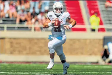  ?? John E. Moore III / Getty Images ?? Texas quarterbac­k Sam Ehlinger scrambles against Texas Tech on Saturday at Jones AT&T Stadium in Lubbock, Texas.