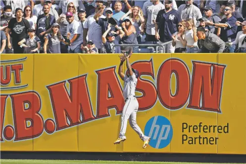  ?? ADAM HUNGER/ASSOCIATED PRESS ?? Rays left fielder Randy Arozarena makes a catch on a fly out by the Yankees’ Aaron Judge during the third inning of Saturday’s game in New York.