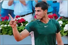  ?? PAUL WHITE/AP PHOTO ?? Carlos Alcaraz celebrates after winning the final match against Alexander Zverev at the Madrid Open on Sunday in Madrid, Spain.