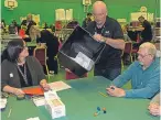  ??  ?? The first postal ballot box is opened right on 10pm at the Michael Woods Centre in Glenrothes and Scottish Lib Dem leader Willie Rennie after casting his vote in Keltybridg­e.