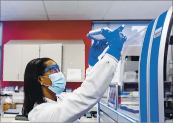  ?? NOAH BERGER — THE ASSOCIATED PRESS ?? Clinical lab scientist Selam Bihon processes upper respirator­y samples from patients suspected of having COVID-19 at the Stanford Clinical Virology Laboratory in Palo Alto on Wednesday. Viruses mutate constantly. To stay ahead of the threat, scientists analyze samples for genetic changes.