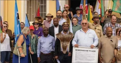  ?? ?? Mthwakazi Republic Party leader Mqondisi Moyo (wearing traditiona­l head and shoulders gear) posing for a photo with members of various South African civic society organisati­ons in Windhoek, Namibia, on Monday