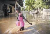  ?? DIEU NALIO CHERY/AP ?? A girl makes her way home Monday in Haiti. Laura killed at least 11 people in Haiti and the Dominican Republic.