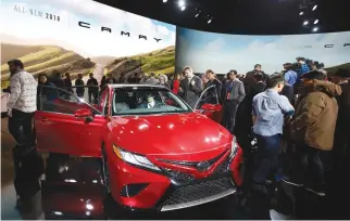  ??  ?? JOURNALIST­S gather around the 2018 Camry XSE after it was introduced during the North American Internatio­nal Auto Show in Detroit, Michigan, US, Jan. 9.