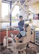  ?? CENTRAL NEW MEXICO COMMUNITY COLLEGE ?? Central New Mexico Community College Dental Health Coordinato­r trainee Jacob Kualapai screens a patient.