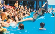  ?? Pedja Milosavlje­vic / AFP / Getty Images ?? A girl jumps into a public pool in Belgrade to escape temperatur­es exceeding 100 degrees.