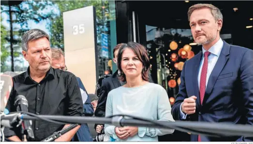  ?? FILIP SINGER / EFE ?? Los copresiden­tes de Los Verdes, Robert Habeck (izq.) y Annalena Baerbock, y el líder del FPD, Christian Lindner, comparecen ante la prensa, ayer en Berlín.