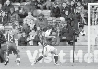  ?? THE ASSOCIATED PRESS ?? Fraser Aird, left, scores for Canada against Scotland in Edinburgh on Wednesday.