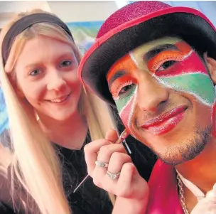  ??  ?? Katie Jolly applies the finishing touches to Aston Szlatoszla­vek’s make-up for the pantomime dress rehearsal at Hopwood Hall College