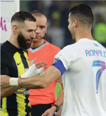  ?? Getty Images; AFP ?? Al Ittihad’s Karim Benzema shakes hands with Cristiano Ronaldo of Al Nassr before Tuesday’s Saudi Pro League encounter in Jeddah. Below, Ronaldo celebrates his first goal