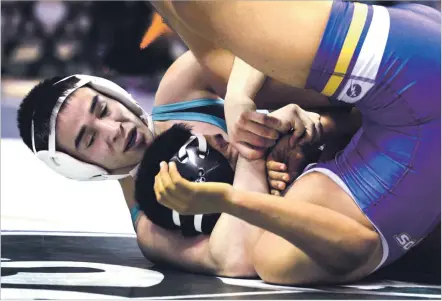  ?? CLYDE MUELLER/NEW MEXICAN FILE PHOTO ?? Capital’s Jose Tapia, rear, pins Kirtland Central’s Jalen Platero to win the 138-pound match at the state wrestling championsh­ips Feb. 17 in Rio Rancho. Tapia on Wednesday signed a letter of intent to compete at Boise State University