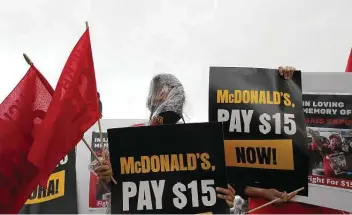  ?? Jon Shapley / Staff photograph­er ?? During a May protest outside of a Mcdonald’s location in Houston, Marina Ramirez takes part in a moment of silence for a man who died from Covid-related complicati­ons.