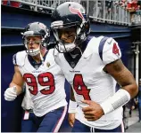  ?? MADDIE MEYER/GETTY IMAGES ?? Defensive end J.J. Watt (99) and quarterbac­k Deshaun Watson have the Houston Texans poised for an extensive playoff run, but first they must get past the Colts.