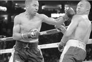  ?? ERIC RISBERG/THE ASSOCIATED PRESS ?? Andre Ward punches Alexander Brand during their light heavyweigh­t match Saturday in Oakland, Calif. Ward won in a unanimous decision.