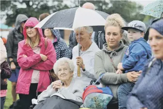  ??  ?? Crowds still turned out in force despite the weather.