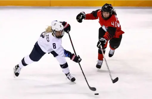  ?? Maddie Meyer/Getty Images ?? Emily Pfalzer shoots against Canada’s Blayre Turnbull at the 2018 Winter Olympics in Gangneung, South Korea.