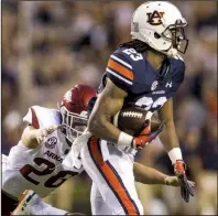  ?? NWA Democrat-Gazette/BEN GOFF ?? Arkansas defensive back Ryder Lucas tries to tackle Auburn’s Ryan Davis as he returns a punt in the first quarter Saturday at Jordan-Hare Stadium in Auburn, Ala. Davis’ 48-yard return set up the Tigers’ first touchdown of the game.