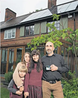  ??  ?? Energy savers: Jurgen Huber and his wife, Zoe, and children, Laurie and Anouk, at their eco-friendly home in west London