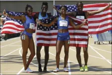  ??  ?? FROM LEFT: Christina Manning, Dawn Harper, Kendra Harrison, and Nia Ali pose for photos with U.S. flags after running the women's 100 hurdles at the U.S. Track and Field Championsh­ips on Saturday in Sacramento. AP PHOTO