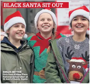  ??  ?? BLACK SANTA SIT OUT SMILES BETTERGirl­s from Kildare Place National School choir at St Ann’s Church, Dublin