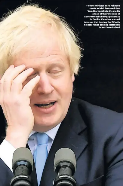  ??  ?? > Prime Minister Boris Johnson reacts as Irish Taoiseach Leo Varadkar speaks to the media ahead of their meeting at Government Buildings yesterday in Dublin. Varadkar warned Johnson that leaving the EU with no deal risked causing instabilit­y in Northern Ireland