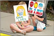  ?? (AP Photo/ Rick Bowmer) ?? Lucie Phillips, 6, and her brother, David Phillips, 3, join parents and students during a rally at Utah State School Board Office calling for mask mandate Friday in Salt Lake City. The school year is days away for many kids in Utah and public health experts are worried about whether kids too young to get vaccinated will stay safe in school amid a wave of coronaviru­s cases.