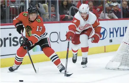  ?? CHRIS SWEDA/CHICAGO TRIBUNE PHOTOS ?? Blackhawks center Max Domi (13) makes a pass against the Red Wings on Friday at the United Center.