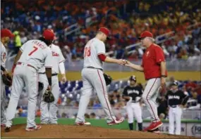  ?? WILFREDO LEE — THE ASSOCIATED PRESS ?? Phillies manager Pete Mackanin takes the ball from relief pitcher Andrew Bailey during the sixth inning against the Miami Marlins on Wednesday.