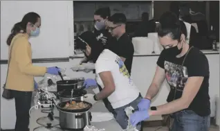  ?? PHOTO TOM BODUS ?? Volunteers fill food trays for the Imperial Valley LGBT Resource Center’s Community Thanksgivi­ng Dinner held Thursday at the Elks Lodge in El Centro.