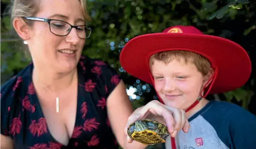  ?? PHOTO: SARA MEIJ/ FAIRFAX NZ ?? ‘‘I’m a wee bit worried about it being lonely as well, because it’s just one turtle on its own.’’
Kate Stoneman Nelson Central School teacher Kate Stoneman and pupil Nate Morris are looking at the turtle that was found over the weekend.
