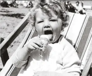  ??  ?? A child devours an ice cream on the sands of Cliftonvil­le, Kent in August 1954