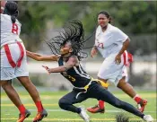  ??  ?? Glades Central’s Tykese Butts reaches for Miami Edison quarterbac­k Tatyana Fremont’s flag in a Class 1A state semifinal at Boca Raton High on Saturday.