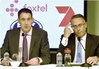  ?? — AFP ?? Cricket Australia chief executive James Sutherland (left) speaks with chief executive officer of Foxtel, Patrick Delany.