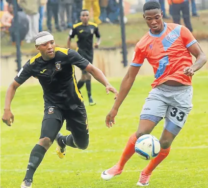  ?? Picture: SUPPLIED ?? IN HOT PURSUIT: Mthatha Bucks’ striker and current top goalscorer, Mpho Erasmus, left, challenges Witbank Spur’s Marvin Sikhosana for the ball during their National First Division encounter where they drew 1-1 at the Mthatha Stadium over the weekend