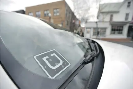  ?? NABIL K. MARK/CENTRE DAILY TIMES VIA THE ASSOCIATED PRESS ?? An Uber decal is displayed in a car owned by a part-time Uber driver.