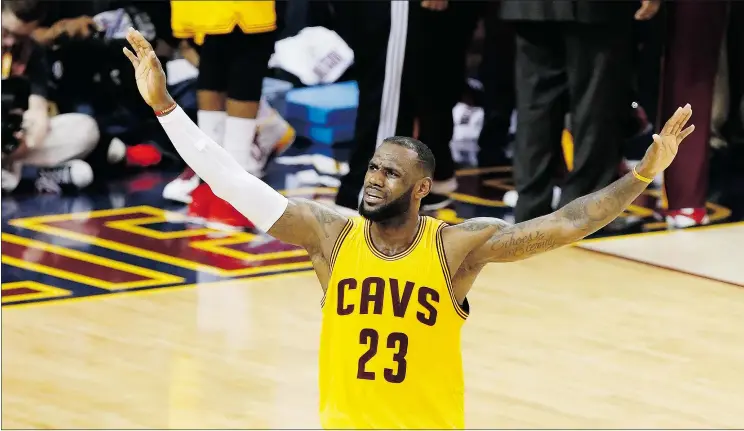  ?? — AP ?? Cleveland Cavaliers forward LeBron James urges on the crowd during the second half of Game 3 of the Finals against the Golden State Warriors in Cleveland on Tuesday.