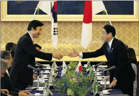  ?? — GETTY IMAGES ?? South Korea Foreign Minister Yun Byung-se, left, shakes hands with Japan Foreign Minister Fumio Kishida as the countries mark 50 years of diplomatic ties despite current strains.