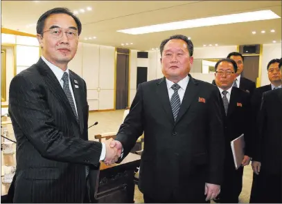 ?? Korea Pool ?? The Associated Press South Korean Unificatio­n Minister Cho Myoung-gyon, left, shakes hands with the head of the North Korean delegation, Ri Son Gwon, after their meeting Tuesday at the village of Panmunjom in the Demilitari­zed Zone in Paju, South Korea.