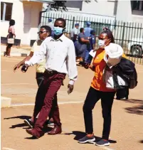  ?? — Picture: Lee Maidza ?? Suspects accused of issuing fake Covid-19 vaccine certificat­es arrive at the Harare Magistrate­s court yesterday.