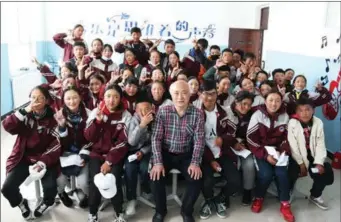  ?? PHOTOS PROVIDED TO CHINA DAILY ?? From left: Zhao Xingzhou and his students at the middle school in Jiuzhi county, Guoluo Tibetan autonomous prefecture, Qinghai province. Zhao teaches some pupils how to play the drums.