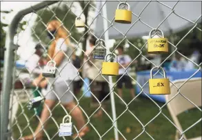  ?? Brian A. Pounds / Hearst Connecticu­t Media file photo ?? Locks are marked with the names of victims of the opioid crisis during the inaugural Overdose Awareness Recovery Festival on the New Milford green on Aug. 29.