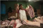  ?? ISMAEL FRANCISCO — THE ASSOCIATED PRESS ?? A meat vendor sells pork at a private market in Havana, Cuba, Friday.