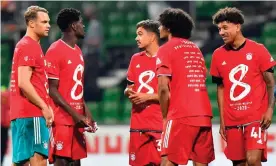  ?? Photograph: Martin Meissner/AFP/Getty Images ?? Bayern Munich’s players celebrate wearing their shirts to mark an eighth title on the spin, after a 1-0 win at Werder Bremen.