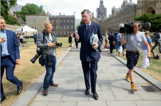  ?? AFP ?? Brexit campaigner Jacob Rees-Mogg talks to the media outside the Houses of Parliament after David Davis resigns from government in London. —