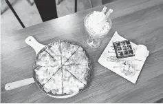  ?? — AFP photo ?? Various dishes including durian flavoured ice cream, waffles and pizza served at the cafe.