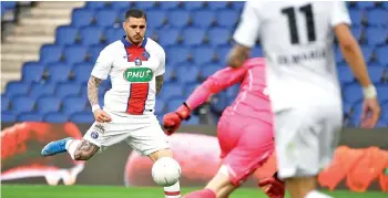  ??  ?? Paris Saint-Germain’s Argentinia­n forward Mauro Icardi (L) scores his team’s fourth goal during the French Cup quarter-final football match against SCO Angers at the Parc des Princes stadium in Paris. - AFP photo