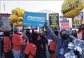  ?? Yuri Gripas / TNS ?? Pro-life and pro-abortion rights protesters rally outside as the U.S. Supreme Court hears arguments in “Dobbs v. Jackson Women’s Health Organizati­on” in Washington, D.C., on Wednesday.