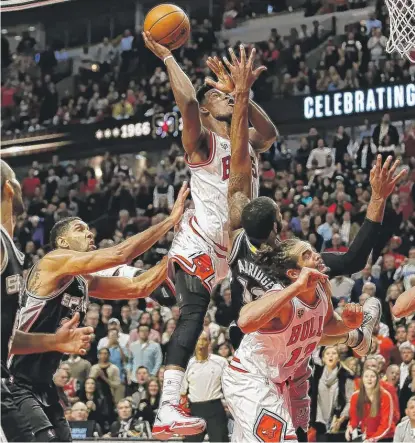  ??  ?? Jimmy Butler (14 points on 5-for-9 shooting) drives to the hoop. Butler sank two key free throws with 10.6 seconds remaining.